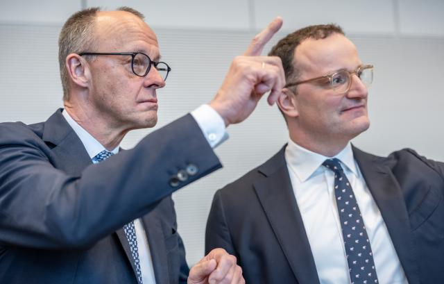 24 March 2026, Berlin: German Chancellor Friedrich Merz (L) stands next to Jens Spahn, CDU/CSU parliamentary group leader in the Bundestag, at the start of the parliamentary group meeting of the Christian Democratic Union in the German Parliament (Bundestag). Photo: Michael Kappeler/dpa
