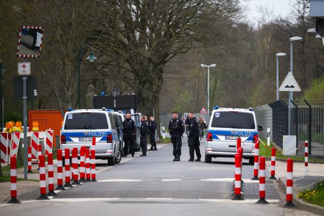 24 March 2026, North Rhine-Westphalia, Juelich: Police officers stand by a fence surrounding the interim storage facility and patrol the area. Photo: Christoph Reichwein/dpa