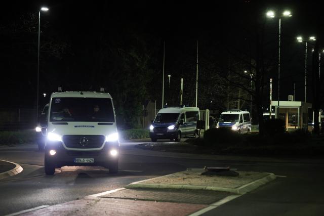 24 March 2026, North Rhine-Westphalia, Juelich: Police vehicles leave the interim storage facility on the grounds of the Jülich Research Center ahead of a Castor transport scheduled to travel through North Rhine-Westphalia from Jülich to Ahaus. Photo: Christoph Reichwein/dpa
