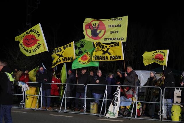 25 March 2026, North Rhine-Westphalia, Ahaus: People hold banners during an anti-nuclear demonstration against the Castor transports along the route near Ahaus. Photo: Christoph Reichwein/dpa