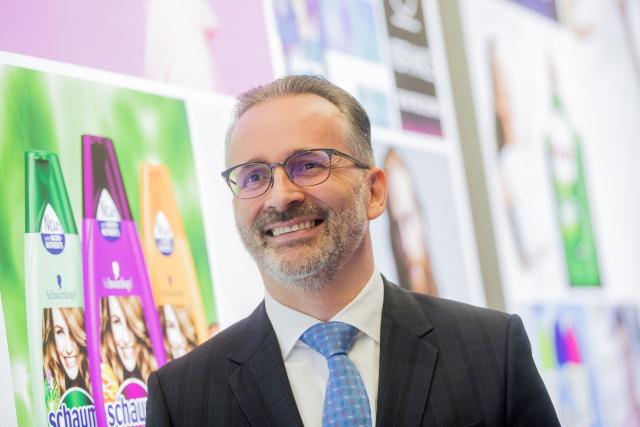 FILED - 21 February 2019, North Rhine-Westphalia, Düsseldorf: Carsten Knobel, Then Henkel's Chief Financial Officer, and current CEO stands infront of a neon sign before the start of the annual results press conference. Photo: Rolf Vennenbernd/dpa