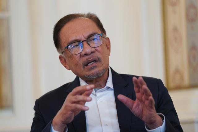 FILED - 15 March 2024, Hamburg: Malaysian Prime Minister Anwar Ibrahim speaks during an interview with the German Press Agency at the Hotel Atlantic Hamburg. Photo: Marcus Brandt/dpa