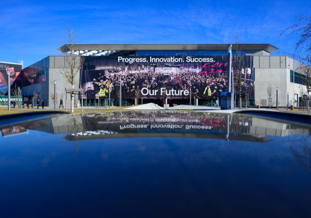 FILED - 02 March 2026, Brandenburg, Gruenheide: A huge banner (Progress. Innovation. Success. Our Future) hangs on the facade at the main entrance to the Tesla Gigafactory Berlin-Brandenburg. Photo: Patrick Pleul/dpa