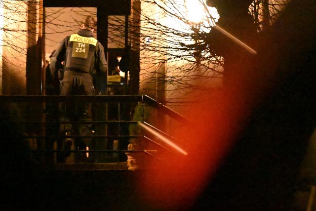 25 March 2026, Thuringia, Fretterode: Police officers stand in front of a house in Fretterode. According to police, a physical altercation involving journalists reportedly took place in the village in northern Thuringia. A dpa reporter on the scene says those involved were a team from Spiegel TV. Photo: -/dpa