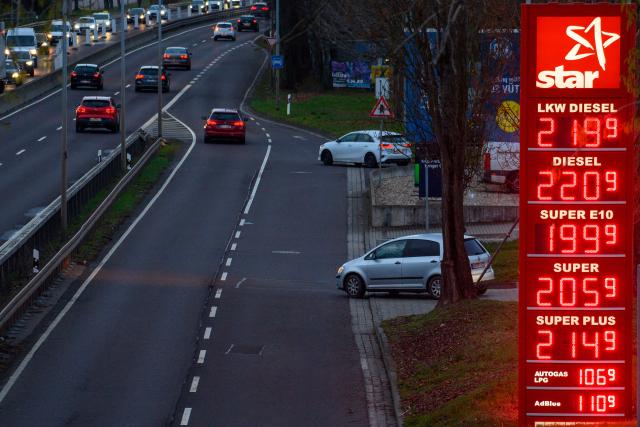 26 March 2026, Saxony-Anhalt, Magdeburg: Cars drive past a gas station price board in the Magdeburg city area. The Bundestag is set to vote on a package of measures regarding fuel prices. Photo: Klaus-Dietmar Gabbert/dpa