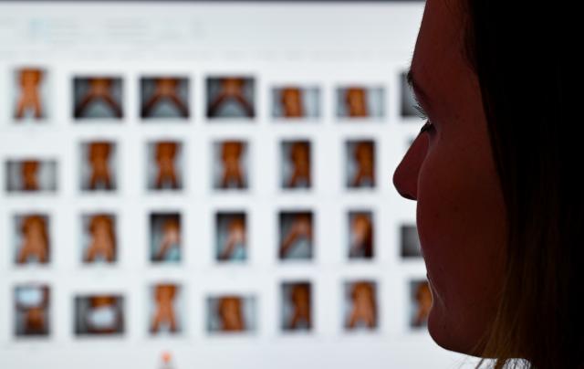 FILED - 23 August 2023, Hesse, Frankfurt/M.: Prosecutor Julia Bussweiler, Child Pornography and Child Sexual Abuse Unit sits in front of a monitor with photos in her office. Photo: Arne Dedert/dpa