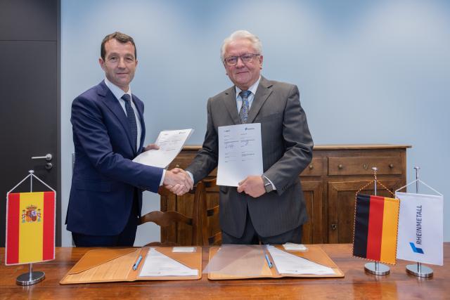 PRODUCTION - 26 March 2026, North Rhine-Westphalia, Duesseldorf: CEO of Rheinmetall AG Armin Papperger (R) and CEO of the Spanish technology company Indra Angel Escribano sign a memorandum of understanding to expand their strategic cooperation in the field of military vehicle systems. Photo: Rolf Vennenbernd/dpa