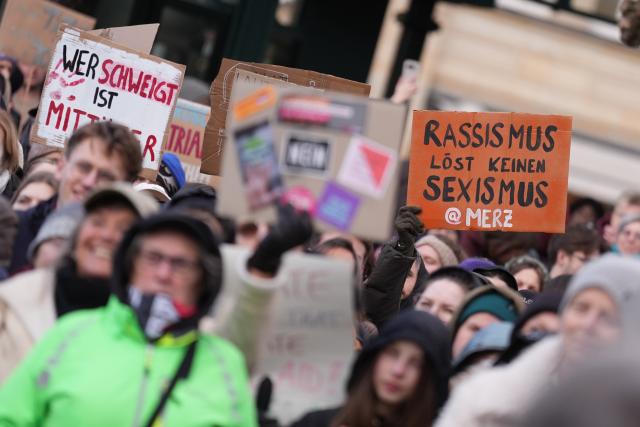 26 March 2026, Hamburg: People hold up signs at Town Hall Square during a demonstration against sexual violence targeting women. Photo: Marcus Brandt/dpa