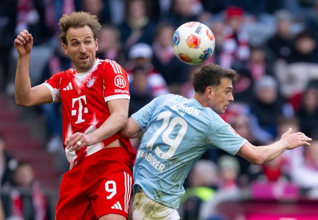 FILED - 21 March 2026, Bavaria, Munich: Bayern Munich's Harry Kane (L) and Union Berlin's Janik Haberer battle for the ball during the German Bundesliga soccer match between Bayern Munich and 1. FC Union Berlin at the Allianz Arena. Photo: Sven Hoppe/dpa - WICHTIGER HINWEIS: Gemäß den Vorgaben der DFL Deutsche Fußball Liga bzw. des DFB Deutscher Fußball-Bund ist es untersagt, in dem Stadion und/oder vom Spiel angefertigte Fotoaufnahmen in Form von Sequenzbildern und/oder videoähnlichen Fotostrecken zu verwerten bzw. verwerten zu lassen.