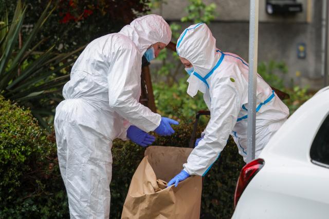 28 March 2026, North Rhine-Westphalia, Witten: Forensic investigators secure evidence in large paper bags following a knife attack. Photo: Christoph Reichwein/dpa