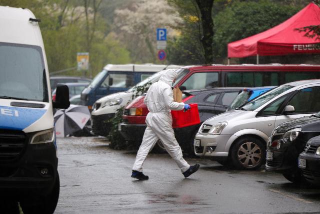 28 March 2026, North Rhine-Westphalia, Witten: A forensic investigator walks across the street toward a crime scene. Photo: Christoph Reichwein/dpa