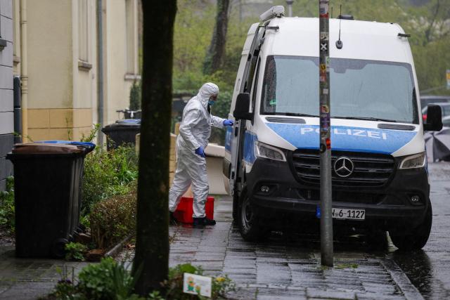 28 March 2026, North Rhine-Westphalia, Witten: A police forensic investigator stands next to a patrol car following a knife attack. Photo: Christoph Reichwein/dpa