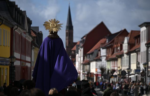 29 March 2026, Thuringia, Heilbad Heiligenstadt: Participants carry a figure of Jesus Christ during the traditional Palm Sunday procession through the streets of Heiligenstadt. Photo: Martin Schutt/dpa