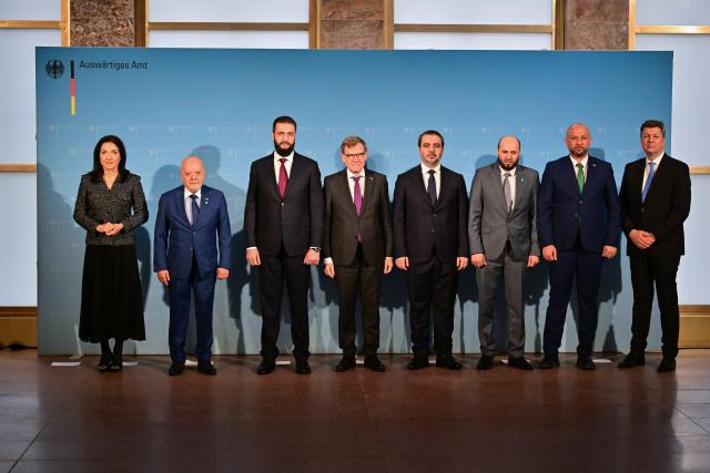 30 March 2026, Berlin: (L-R) Katherina Reiche, German Minister for Economic Affairs and Energy, Mohammad Nidal Alshaar, Minister of Economy in the Syrian Interim Government, Ahmed al-Sharaa, President of the Syrian Interim Government, Johann Wadephul, German Foreign Minister, Asaad Alshaibani, Foreign Minister in the Syrian Interim Government, Mohammed Albashir, Minister of Energy in the Syrian Interim Government, Raed Saleh, Minister of Emergency and Disaster Management in the Syrian Interim Government, and Wolfgang Niedermark, Federation of German Industries, stand together for a family photo in the Federal Foreign Office in Berlin. Photo: Sebastian Christoph Gollnow/dpa