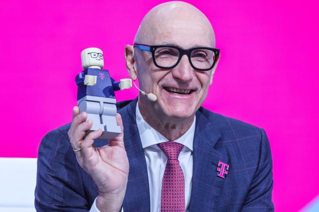 01 April 2026, North Rhine-Westphalia, Bonn: Timotheus Hoettges, CEO of Deutsche Telekom, holds a Lego man at the company's shareholders' meeting. Photo: Oliver Berg/dpa