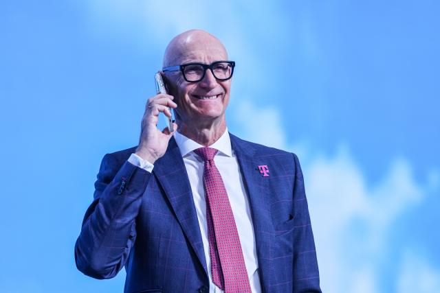 01 April 2026, North Rhine-Westphalia, Bonn: Timotheus Hoettges, CEO of Deutsche Telekom, on the phone at the the company's shareholders' meeting. Photo: Oliver Berg/dpa