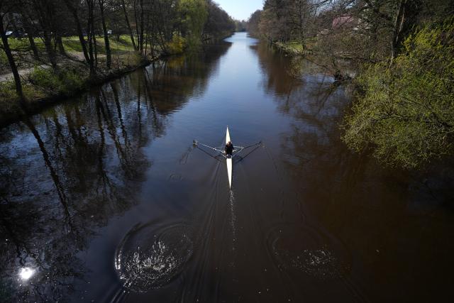 01 April 2026, Hamburg: A woman is kayaking down the Alster toward the Aussenalster in beautiful sunshine. Photo: Marcus Brandt/dpa