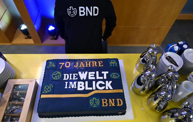 01 April 2026, Berlin: The cake celebrating the 70th anniversary of the Federal Intelligence Service (BND) bears the inscription '70 Years of Keeping an Eye on the World, BND.' The BND has invited the public to an event at its visitor centre. Photo: Elisa Schu/dpa