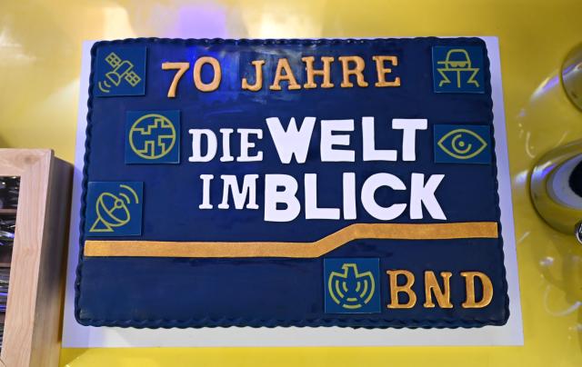 01 April 2026, Berlin: The cake celebrating the 70th anniversary of the Federal Intelligence Service (BND) bears the inscription '70 Years of Keeping an Eye on the World, BND.' The BND has invited the public to an event at its visitor centre. Photo: Elisa Schu/dpa