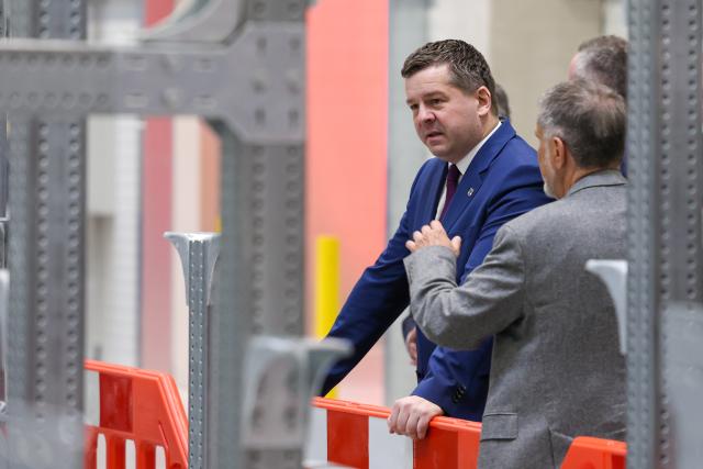 02 April 2026, Saxony-Anhalt, Schoenebeck: Minister-President of Saxony-Anhalt Sven Schulze stands in a production hall at the Mercury Engineering Group's new plant engineering center in Saxony-Anhalt. Photo: Peter Gercke/dpa