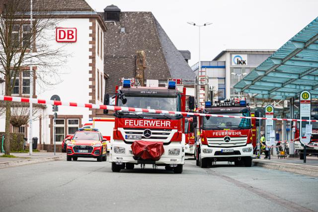 02 April 2026, Lower Saxony, Nordrhein-Westfalen: Fire department vehicles are parked in front of the cordoned-off Herford train station, where Sulfuric acid is leaking from a tank car. Photo: Moritz Frankenberg/dpa