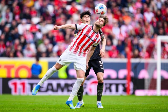 04 April 2026, Baden-Wuerttemberg, Freiburg im Breisgau: Freiburg's Lucas Hoeler in action against Bayern Munich's Min-jae Kim during the German Bundesliga soccer match between SC Freiburg and Bayern Munich at Europa-Park Stadium. Photo: Tom Weller/dpa - IMPORTANT NOTICE: DFL and DFB regulations prohibit any use of photographs as image sequences and/or quasi-video.