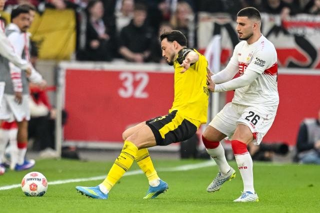 04 April 2026, Baden-Württemberg, Stuttgart: Borussia Dortmund's Ramy Bensebaini in action against Stuttgart's Deniz Undav during the German Bundesliga soccer match between VfB Stuttgart and Borussia Dortmund at the MHPArena. Photo: Harry Langer/dpa - IMPORTANT NOTICE: DFL and DFB regulations prohibit any use of photographs as image sequences and/or quasi-video.