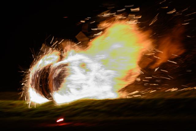 05 April 2026, Hesse, Günsterode: Flaming, straw-filled wagon wheels roll down Kehrenbach Hill during the traditional Burning Wheels Run on Easter Sunday. The custom is intended to symbolically drive away winter. Photo: Swen Pförtner/dpa