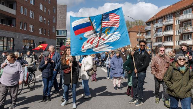 06 April 2026, Hamburg: People hold a large banner during the Easter march under the motto "Not our war!". The annual Easter march was organized by the Hamburg Forum for International Understanding and Global Disarmament. Photo: Markus Scholz/dpa