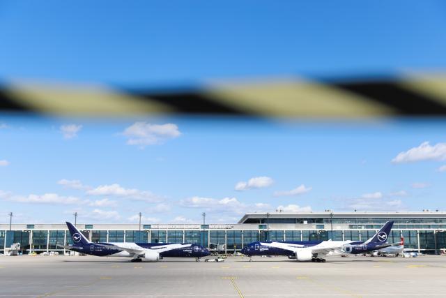 06 April 2026, Brandenburg, Schoenefeld: Two Lufthansa passenger aircraft, a Boeing 787-9 (L) and an Airbus A350-900, are parked nose-to-nose during celebrations marking the 100th anniversary of the first flight at Berlin Brandenburg Airport (BER). Photo: Carsten Koall/dpa