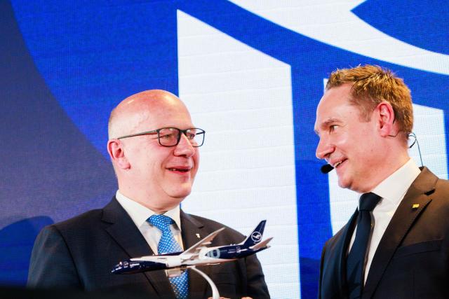 06 April 2026, Brandenburg, Schoenefeld: Kai Wegner (L), Governing Mayor of Berlin, accepts a model of a Lufthansa aircraft from Jens Ritter (R), CEO of Lufthansa Airlines, during celebrations marking the 100th anniversary of the first flight at Berlin Brandenburg Airport (BER). Photo: Carsten Koall/dpa