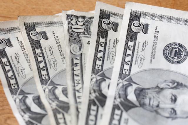 FILED - 19 February 2016, Hamburg: Bank notes of the US dollar lie on a table. Photo: Bodo Marks/dpa