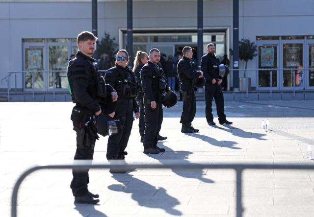 08 April 2026, Saxony-Anhalt, Salzwedel: Police officers stand in front of the Kulturhaus in Salzwedel, providing security for an AfD campaign event. Photo: Matthias Bein/dpa