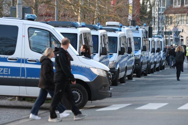 08 April 2026, Saxony-Anhalt, Salzwedel: Police officers stand in front of the Kulturhaus in Salzwedel, providing security for an AfD campaign event. Photo: Matthias Bein/dpa