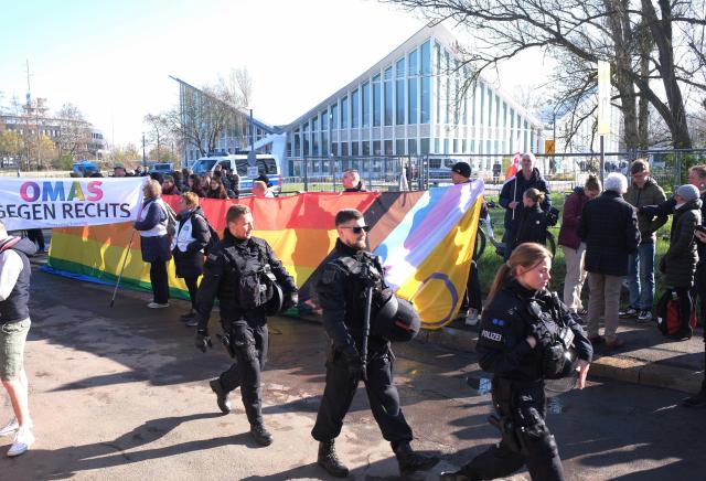11 April 2026, Saxony-Anhalt, Magdeburg: Left-wing activists gather in front of the event hall Hyparschale, and are escorted by the police, during  protest against the state party conference of the Alternative for Germany (AfD) Saxony-Anhalt, which is taking place there. Photo: Sebastian Willnow/dpa