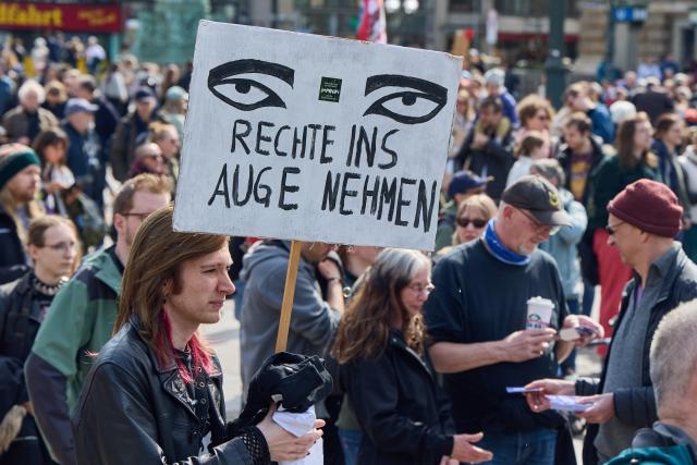 11 April 2026, Hamburg: People take part in a protest organised by the 'Pruef' initiative calling for an investigation into far-right parties. Photo: Georg Wendt/dpa