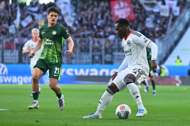 11 April 2026, Lower Saxony, Wolfsburg: Eintracht Frankfurt's Arnaud Kalimuendo (R) and Wolfsburg's Joakim Maehle (L) battle for the ball during the German Bundesliga soccer match between VfL Wolfsburg and Eintracht Frankfurt at the Volkswagen Arena. Photo: Swen Pförtner/dpa - IMPORTANT NOTICE: DFL and DFB regulations prohibit any use of photographs as image sequences and/or quasi-video.