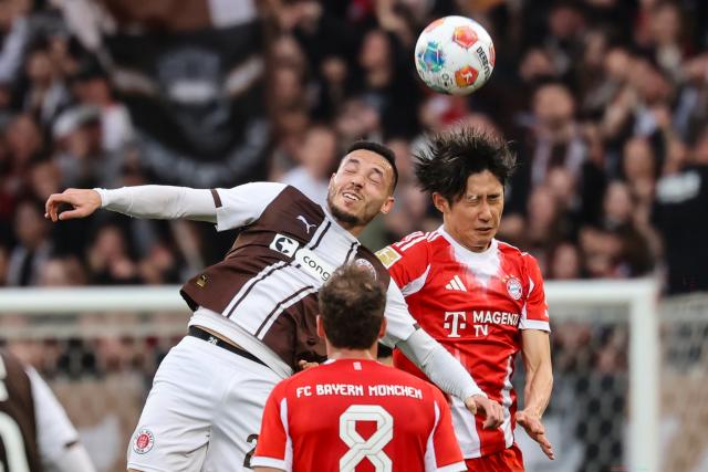 11 April 2026, Hamburg: St. Pauli's Mathias Pereira Lage and Bayern Munich's Hiroki Ito in action during the German Bundesliga soccer match between FC St. Pauli and Bayern Munich at Millerntor Stadium. Photo: Christian Charisius/dpa - IMPORTANT NOTICE: DFL and DFB regulations prohibit any use of photographs as image sequences and/or quasi-video.
