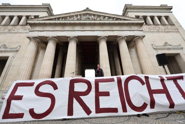 12 April 2026, Bavaria, Munich: A banner reading "Enough is enough!" is displayed at a rally organized by the Green Youth of Munich against sexual violence on Koenigsplatz under the slogan "Against patriarchal violence-for an end to oppression". Photo: Karl-Josef Hildenbrand/dpa