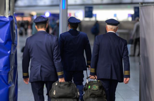 13 April 2026, Hesse, Frankfurt/Main: Pilots walk through a departure hall at Frankfurt Airport. The Vereinigung Cockpit pilots' union has called for work stoppages at Lufthansa and several subsidiaries on Monday and Tuesday. Photo: Hannes P. Albert/dpa