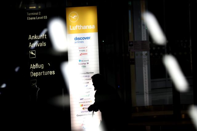 14 April 2026, Bavaria, Munich: A man walks through a revolving door in front of Terminal 2 at Munich Airport early in the morning on the second day of the Lufthansa pilots' strike. Photo: Karl-Josef Hildenbrand/dpa
