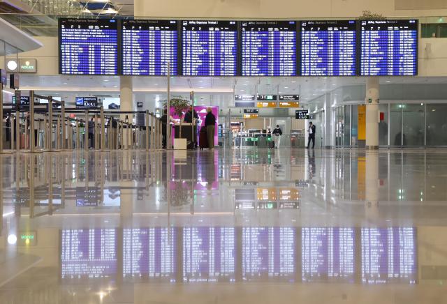 14 April 2026, Bavaria, Munich: An information board is reflected on the floor of the departure hall in Terminal 2 early on the second day of the Lufthansa pilots' strike. Photo: Karl-Josef Hildenbrand/dpa