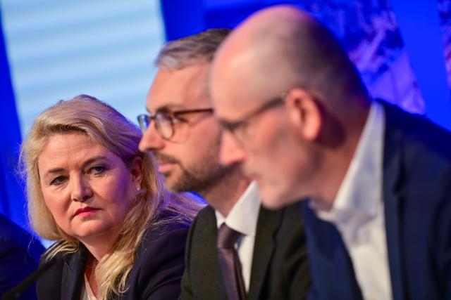 14 April 2026, Berlin: (L-R) Kristin Brinker, the Alternative for Germany (AfD) lead candidate for the Berlin House of Representatives election and state chair of the Berlin AfD, looks at Alexander Bertram, deputy state chair of the Berlin AfD, and Martin Trefzer, state program coordinator of the Berlin AfD, during the presentation of the Berlin AfD's campaign for the House of Representatives election. Photo: Sebastian Christoph Gollnow/dpa