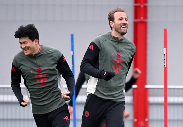 14 April 2026, Bavaria, Munich: Bayern Munich's Min-jae Kim (L) and Bayern Munich's Harry Kane warm up during a training session at the training facility on Saebener Strasse ahead of Wednesday's UEFA Champions League Quarter-final Second Leg soocer match against Real Madrid. Photo: Sven Hoppe/dpa
