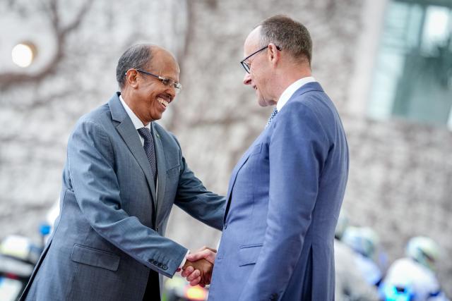 14 April 2026, Berlin: German Chancellor Friedrich Merz (R) receives Mahmoud Ali Youssouf, President of the African Union, in front of the Federal Chancellery. Photo: Kay Nietfeld/dpa