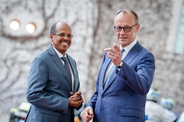 14 April 2026, Berlin: German Chancellor Friedrich Merz (R) receives Mahmoud Ali Youssouf, President of the African Union, in front of the Federal Chancellery. Photo: Kay Nietfeld/dpa
