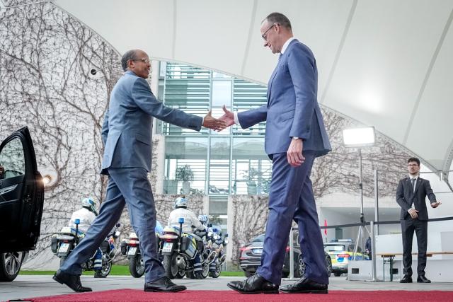 14 April 2026, Berlin: German Chancellor Friedrich Merz (R) receives Mahmoud Ali Youssouf, President of the African Union, in front of the Federal Chancellery. Photo: Kay Nietfeld/dpa