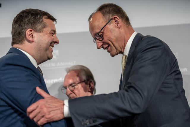 15 April 2026, Berlin: German Chancellor Friedrich Merz shakes hands with Sven Schulze, Minister President of Saxony-Anhalt, during the Saxony-Anhalt Evening under the motto "#modern thinking" at the James-Simon-Galerie. Photo: Michael Kappeler/dpa