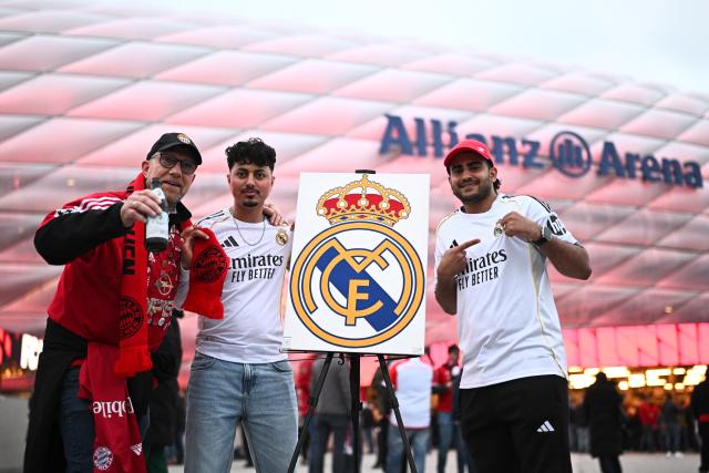 15 April 2026, Bavaria, Munich: Real Madrid and Bayern Munich fans cheer outside the Allianz Arena prior to the start of the UEFA Champions League Quarterfinal Second Leg soccer match between Bayern Munich and Real Madrid. Photo: Tom Weller/dpa