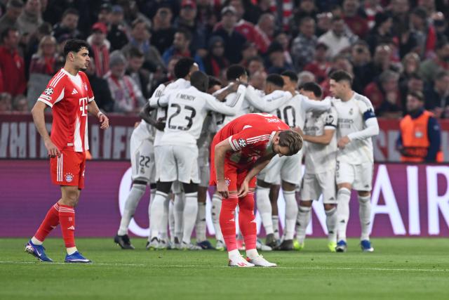 15 April 2026, Bavaria, Munich: Bayern Munich's Harry Kane looks dejected as Real Madrid players celebrate their side's first goal during the UEFA Champions League Quarterfinal Second Leg soccer match between Bayern Munich and Real Madrid at Allianz Arena. Photo: Sven Hoppe/dpa